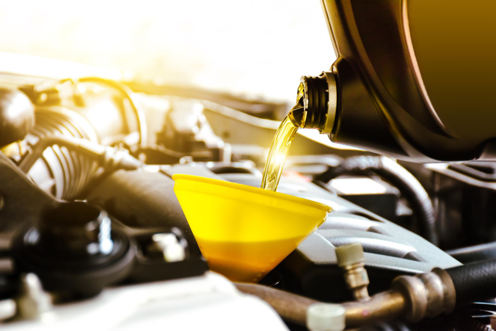 Fast, Professional Oil Changes Near You 4 Filling oil under hood