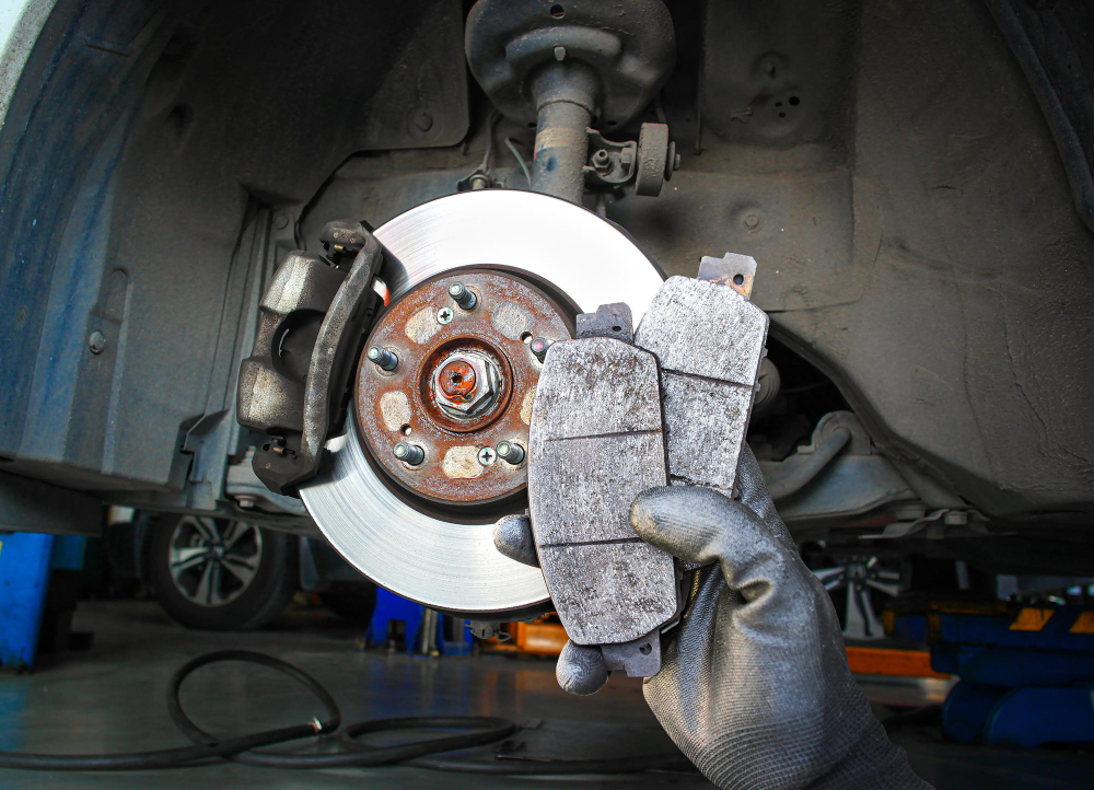 technician holding up brake pads